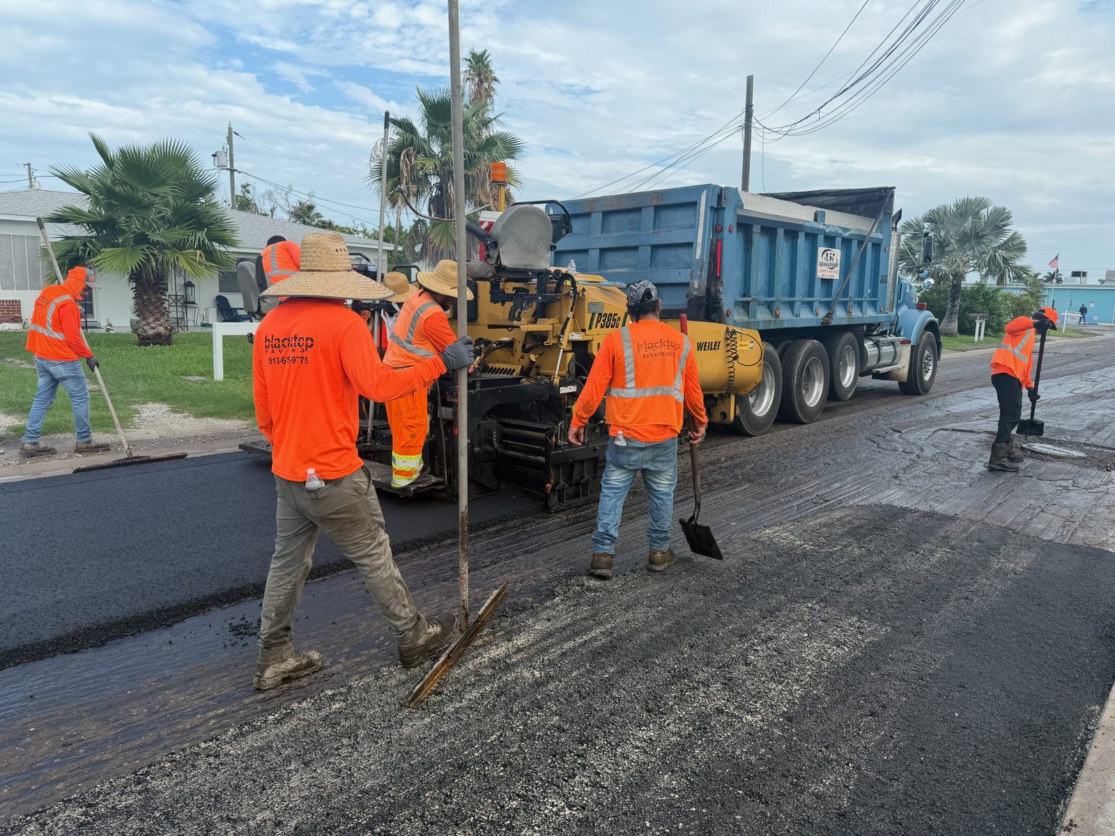 Blacktop Florida crew operating the Weiler P385C tracked paver during residential street paving in Madeira Beach, FL