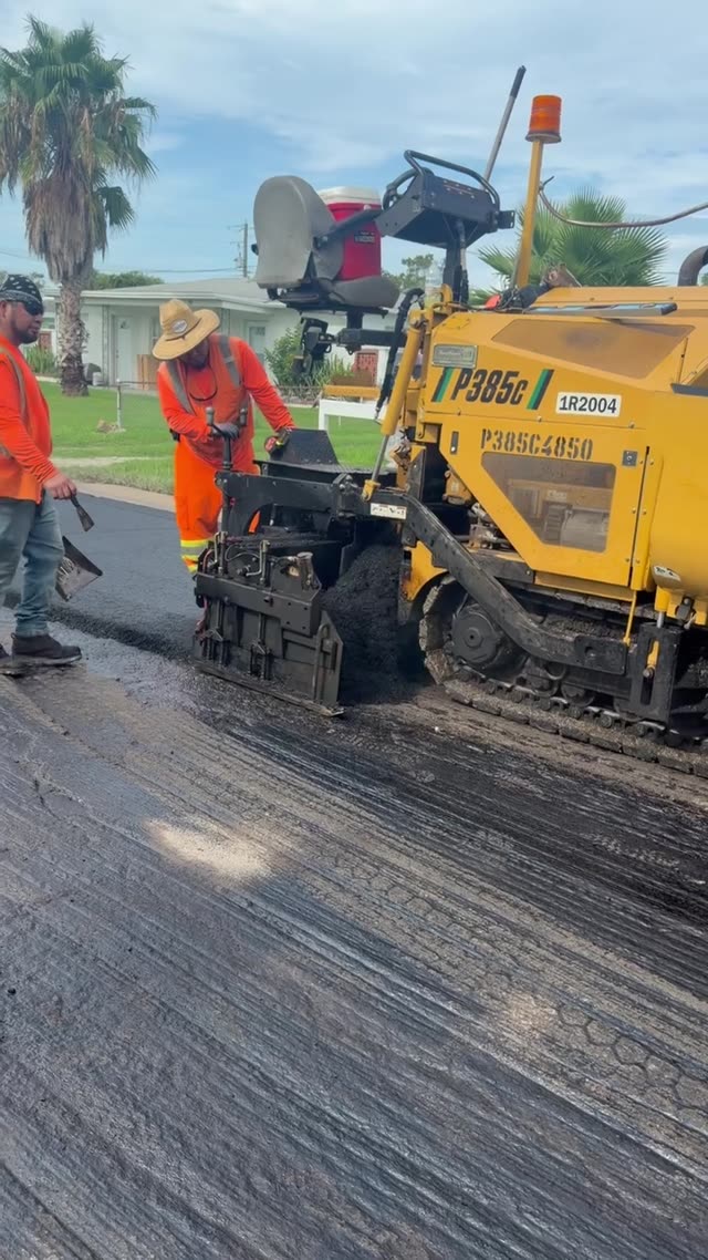 Weiler P385C paver laying fresh asphalt on a residential street in Madeira Beach, FL