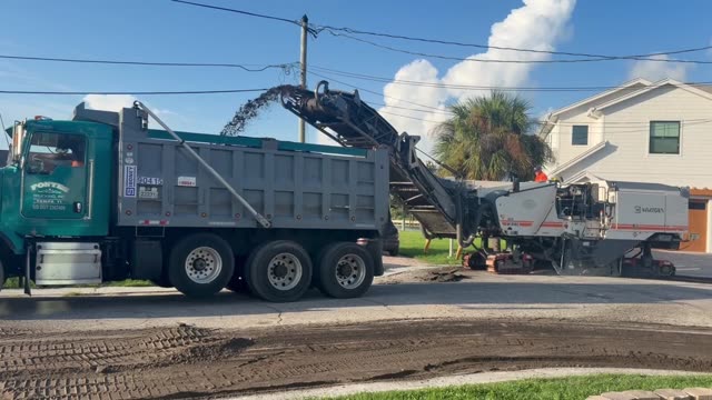 Paving operation in progress on a residential street in Madeira Beach, FL