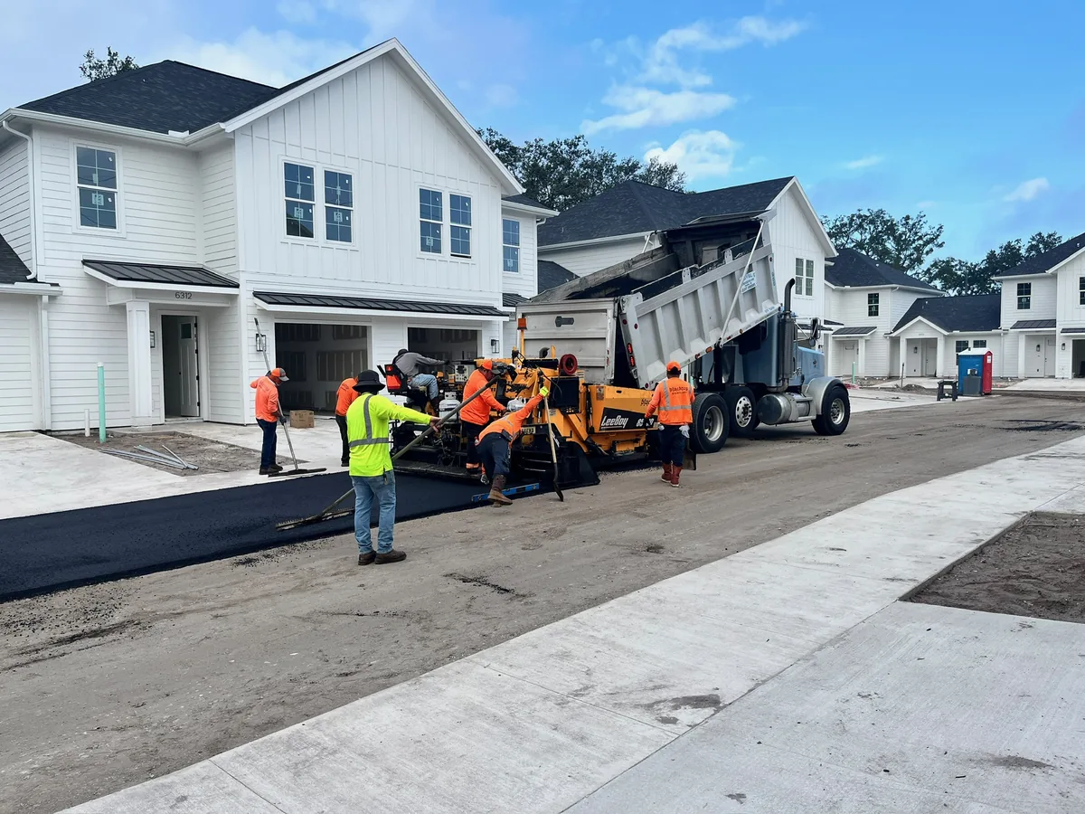 Crew members laying asphalt on a commercial lot — Central Florida