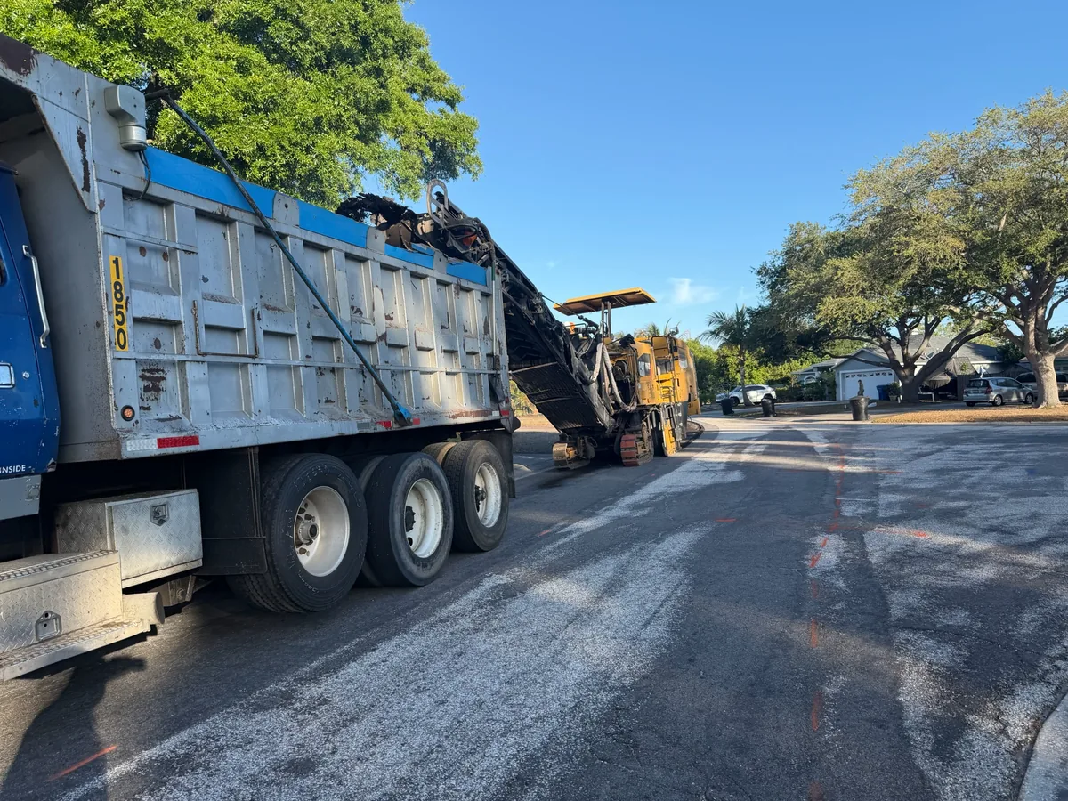 Cold planer loading millings into dump truck — Central Florida