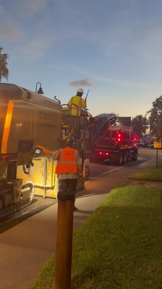 CAT cold planer milling crew at dusk — Central Florida